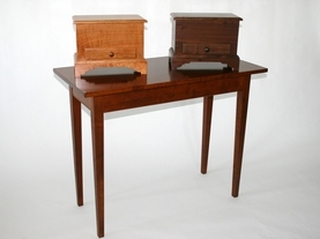 Small chests in cherry (left) and walnut